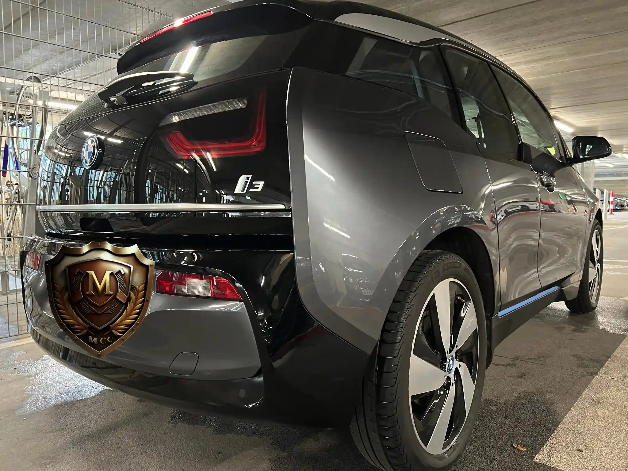 A BMW i3 cleaned in a car park